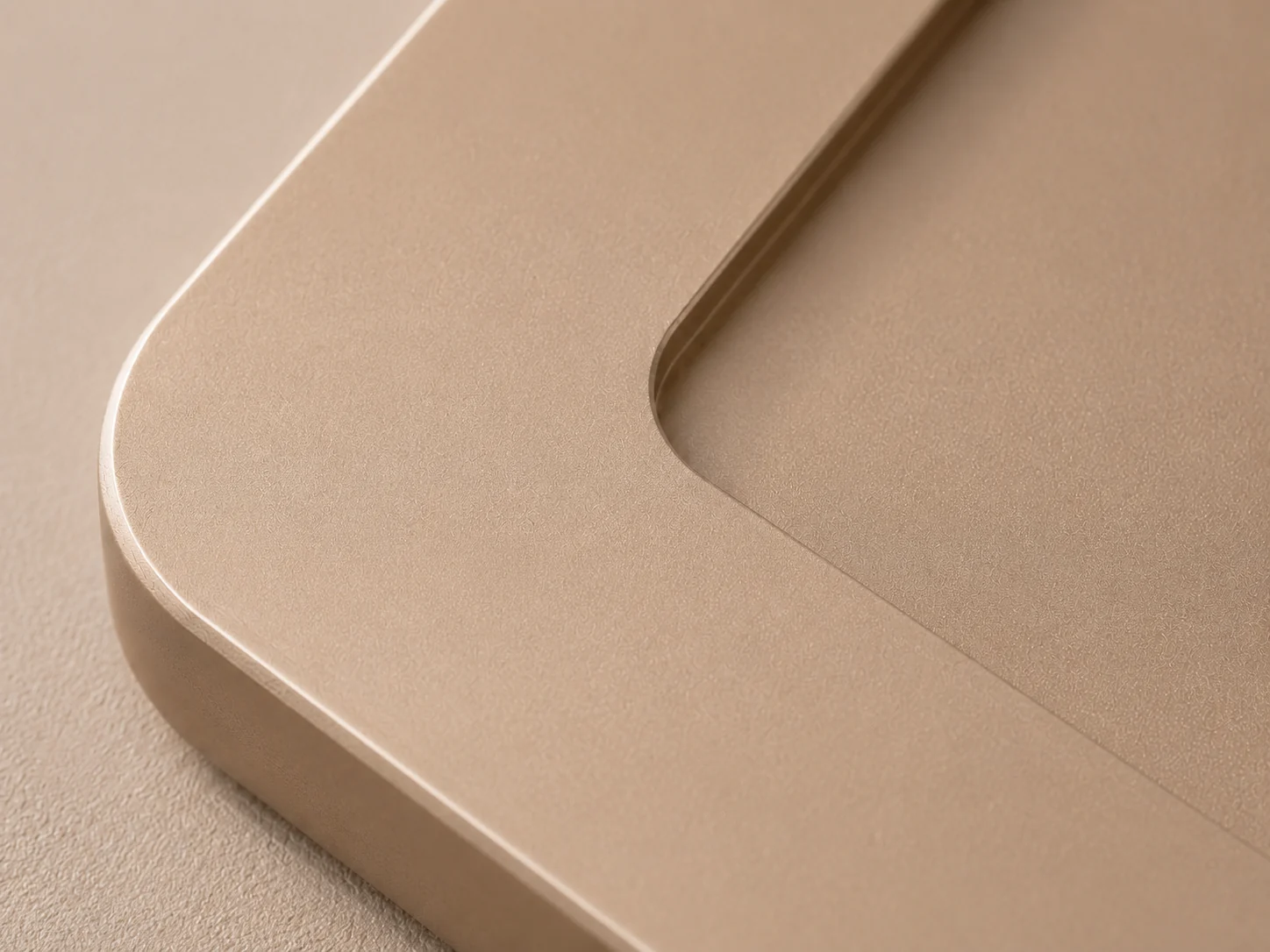 Macro of the soft radius and matte champagne edge of the NOÉ saucer
